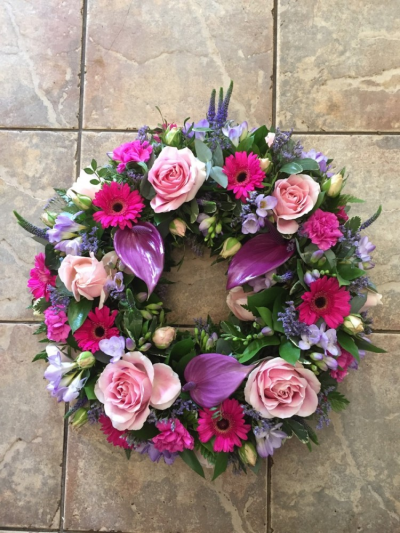 Pink wreath - Pretty shades of pink and purple flowers arranged in a wreath tribute. Available in different sizes. Pink wreath - Pretty shades of pink and purple flowers arranged in a wreath tribute. Available in different sizes.