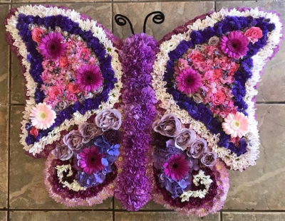 Butterfly - A beautiful butterfly made to order in colours of your choice, a selection of flowers are used to create lots of texture. this tribute is available in 2 sizes. 
Deluxe pictured. Butterfly - A beautiful butterfly made to order in colours of your choice, a selection of flowers are used to create lots of texture. this tribute is available in 2 sizes. 
Deluxe pictured.